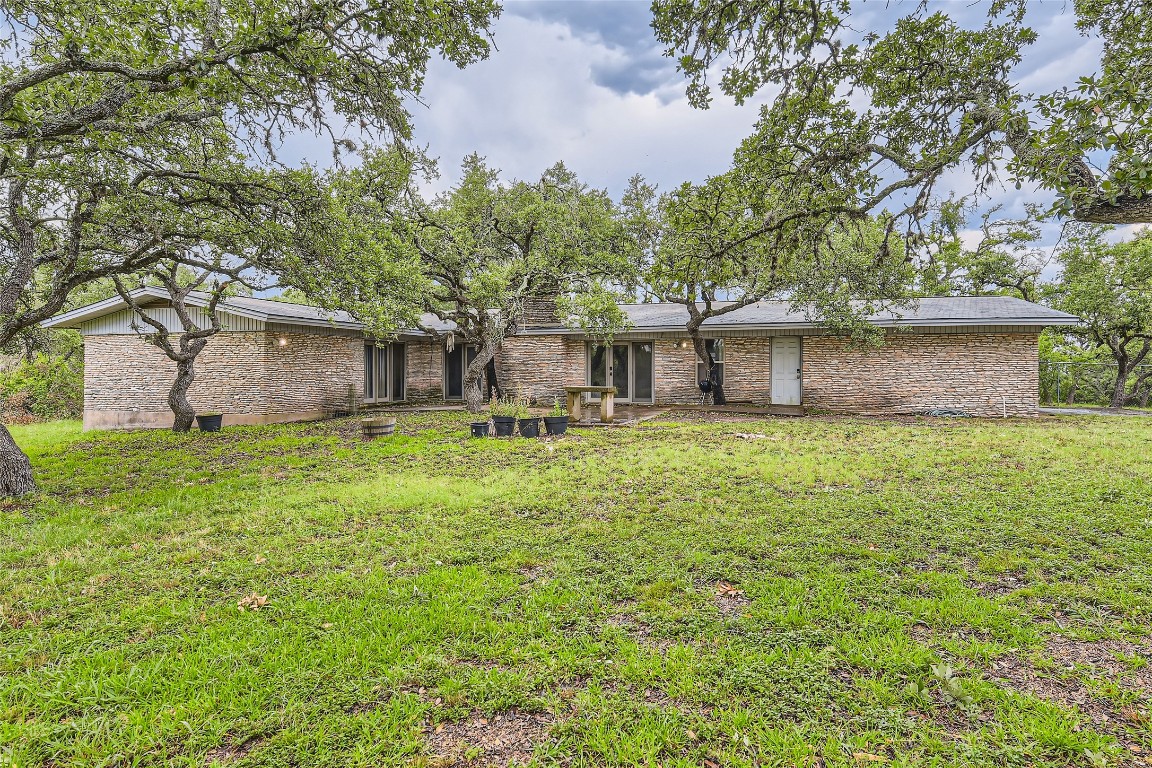 a front view of house with yard and trees