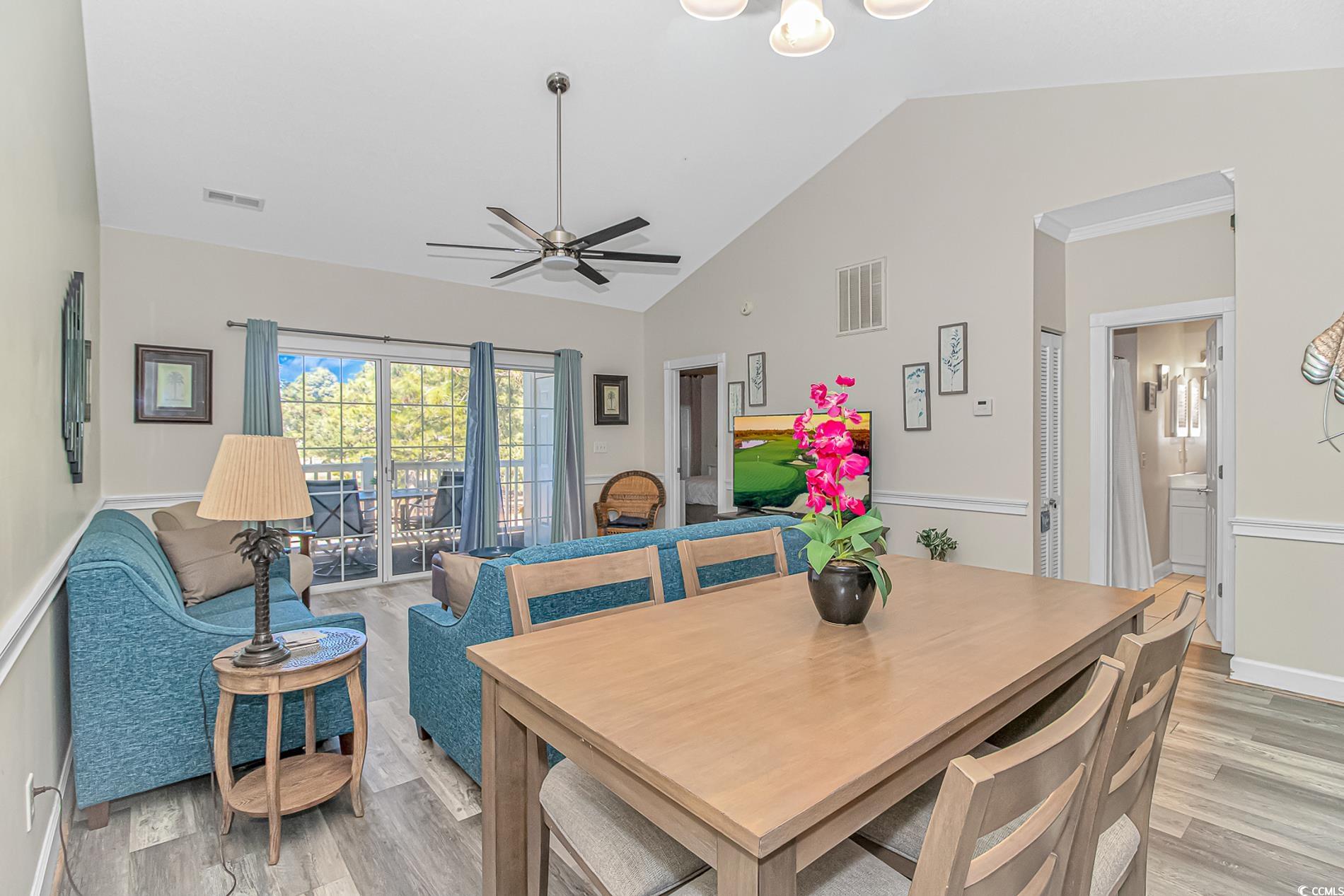 4647 Wild Iris Drive, Unit 303 Myrtle Beach, SC 29577 - Photo 11 of 29 Dining area featuring vaulted ceiling, light wood-style flooring, and ceiling fan