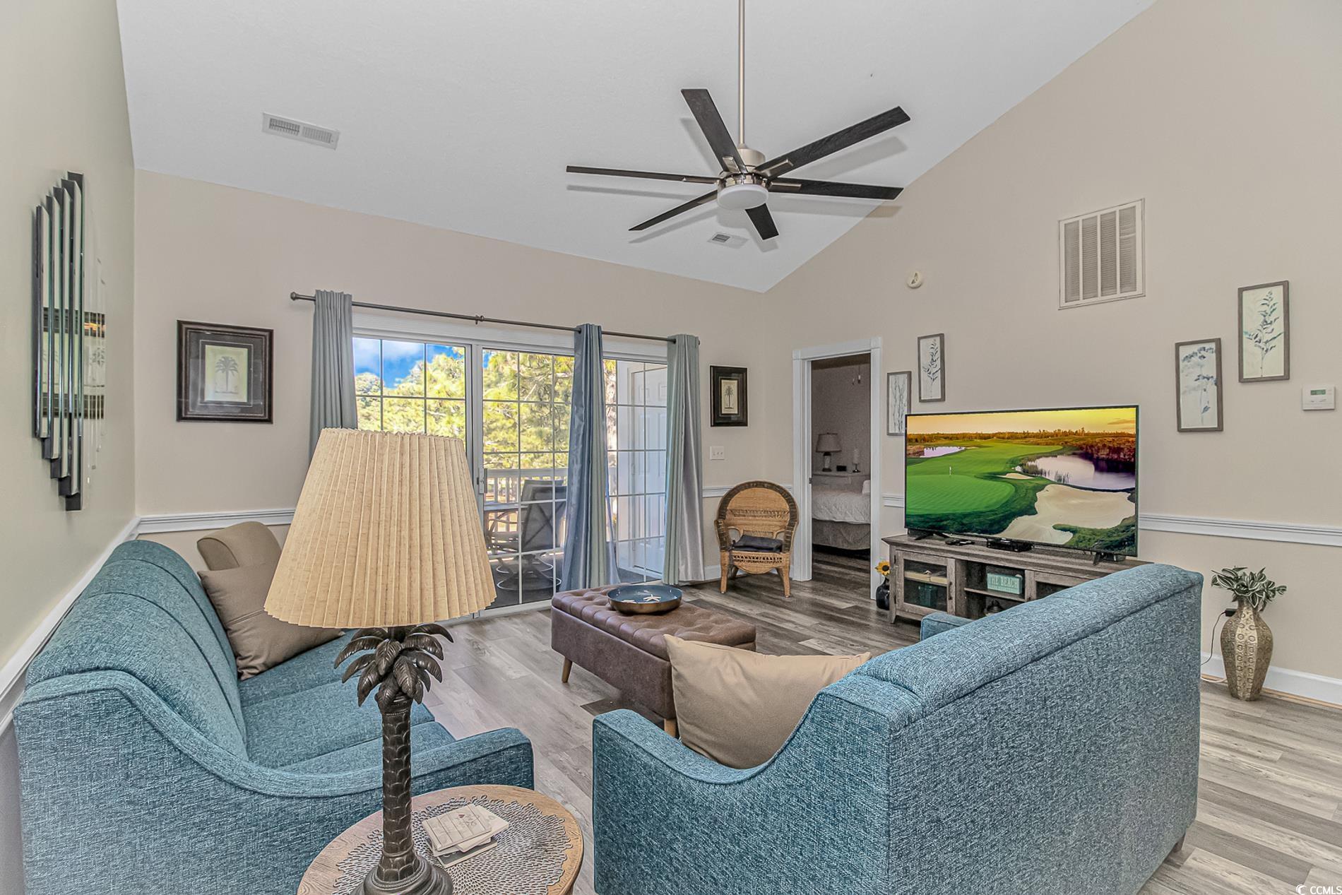 4647 Wild Iris Drive, Unit 303 Myrtle Beach, SC 29577 - Photo 12 of 29 Living area with light wood-type flooring, ceiling fan, and high vaulted ceiling