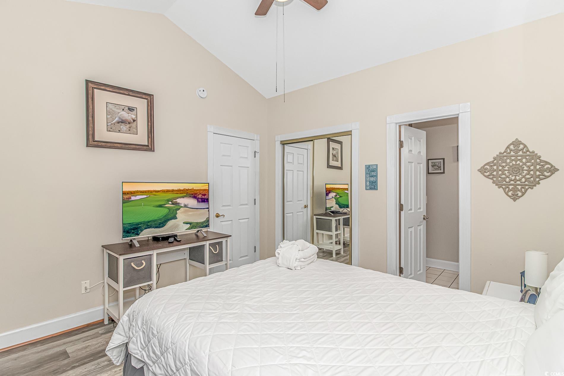 4647 Wild Iris Drive, Unit 303 Myrtle Beach, SC 29577 - Photo 19 of 29 Bedroom featuring vaulted ceiling, a closet, ceiling fan, and light wood-style floors