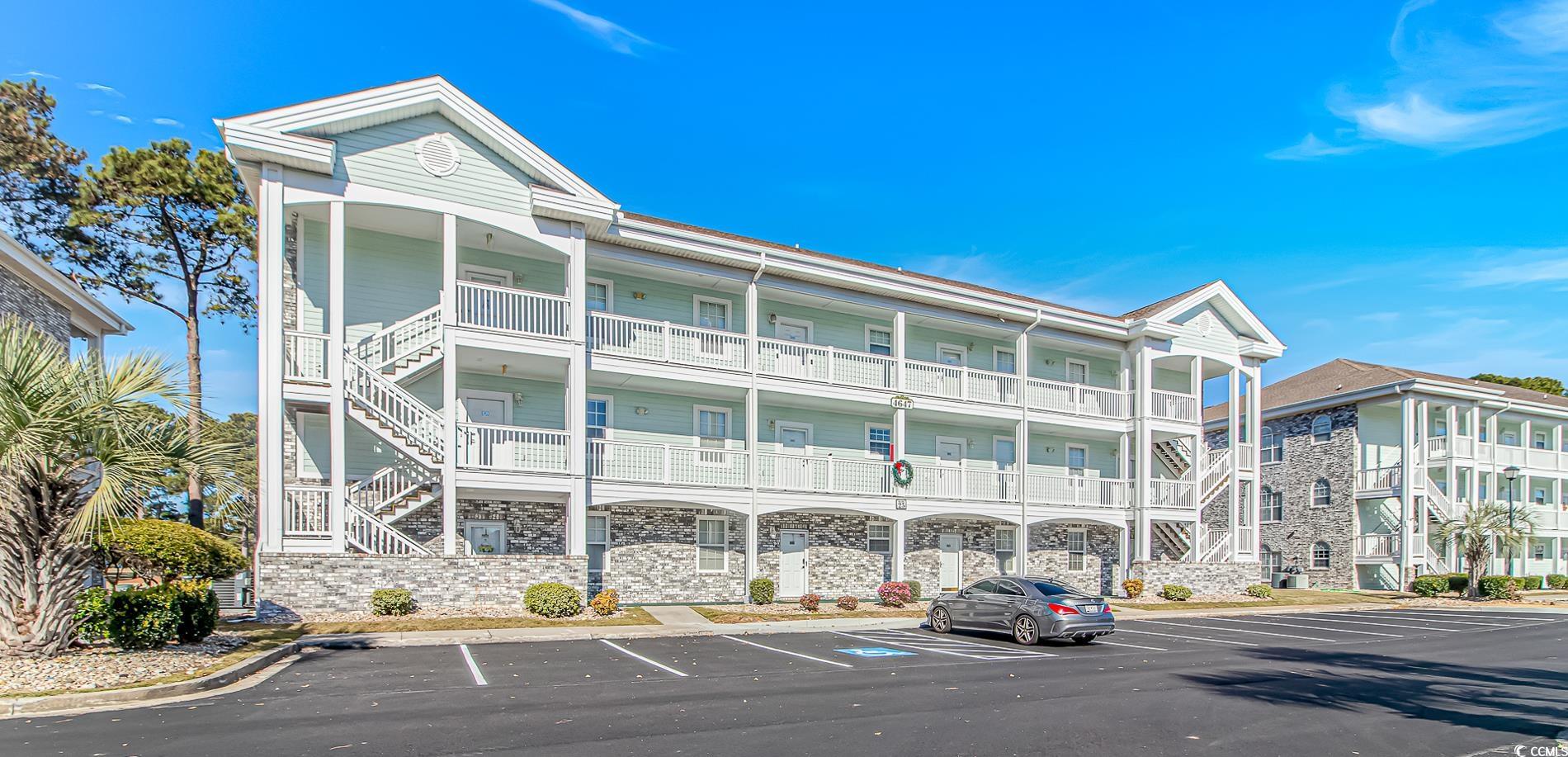 4647 Wild Iris Drive, Unit 303 Myrtle Beach, SC 29577 - Photo 5 of 29 View of apartment building / complex featuring uncovered parking