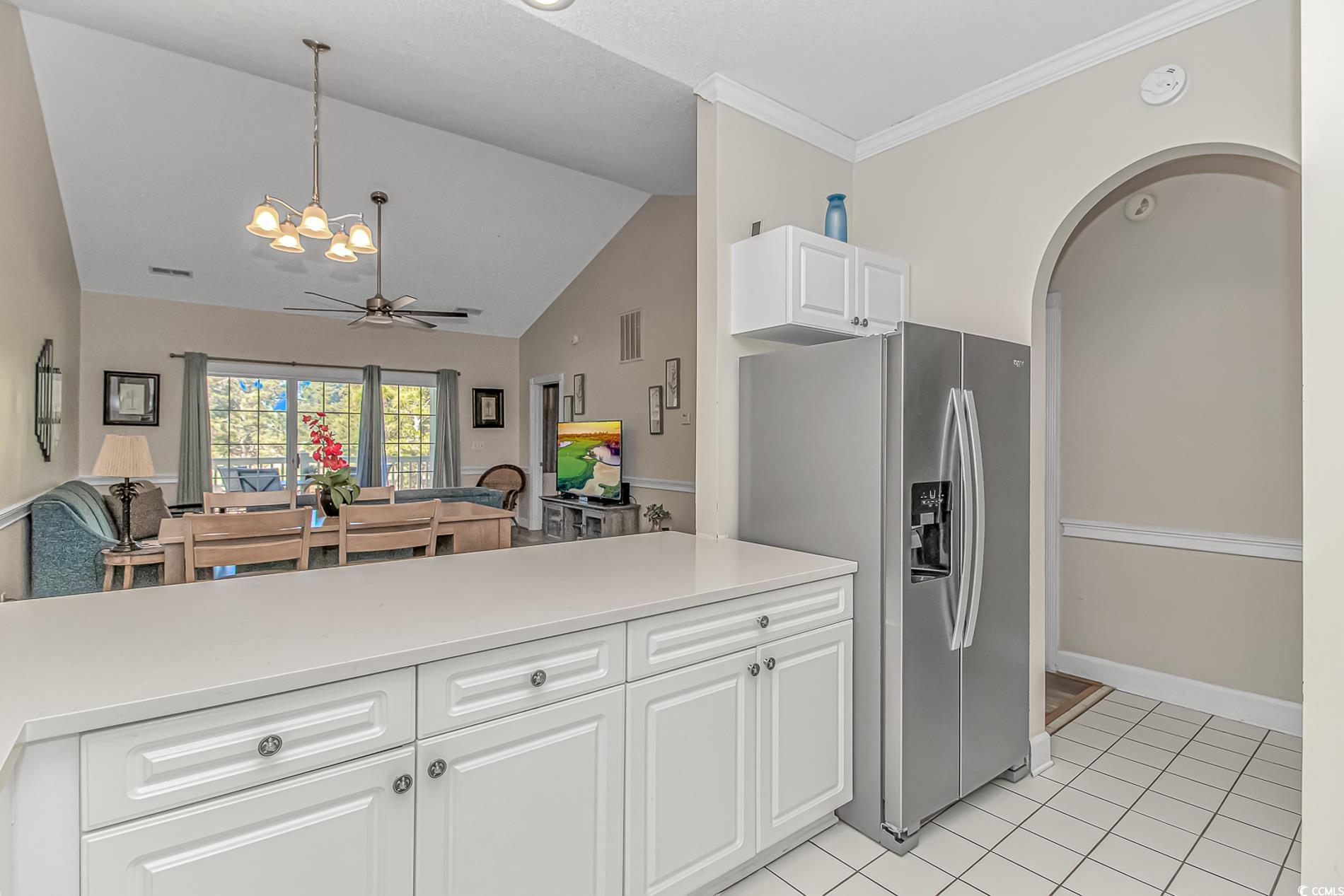 4647 Wild Iris Drive, Unit 303 Myrtle Beach, SC 29577 - Photo 29 of 29 Kitchen featuring open floor plan, white cabinetry, lofted ceiling, a chandelier, and light tile patterned floors