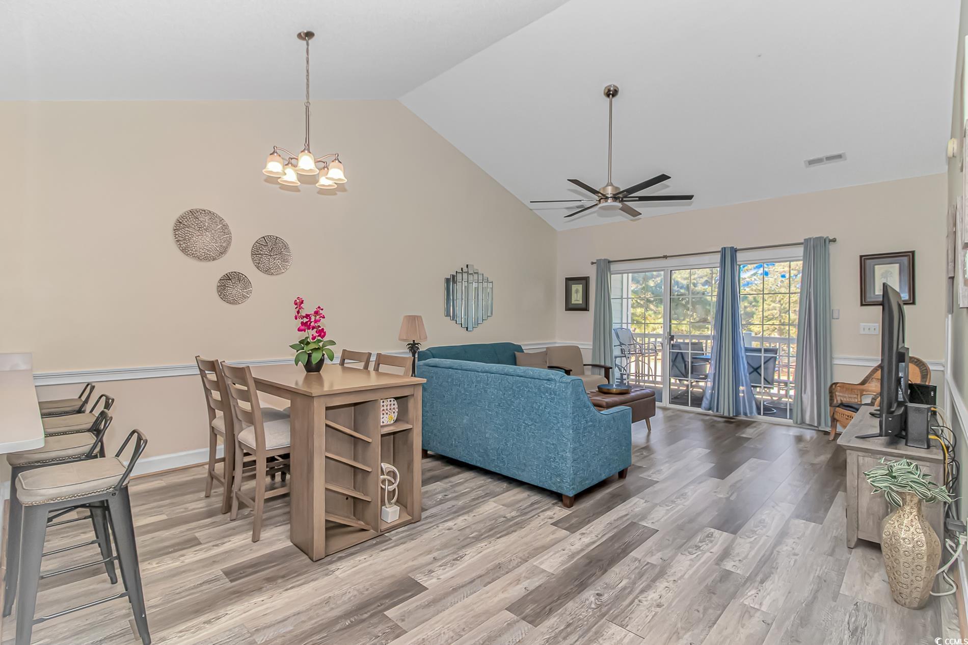 4647 Wild Iris Drive, Unit 303 Myrtle Beach, SC 29577 - Photo 9 of 29 Living room featuring high vaulted ceiling, light wood-style floors, a ceiling fan, and a chandelier