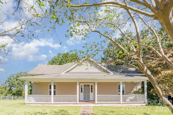 a front view of a house with a garden and plants