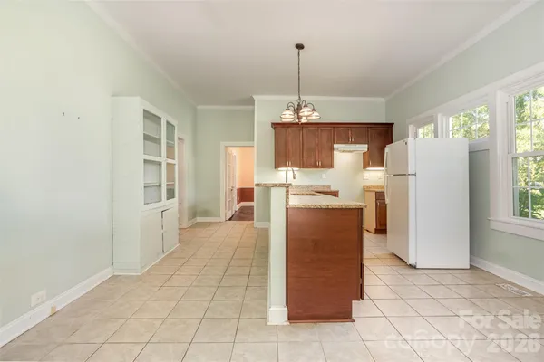 a kitchen with refrigerator and window