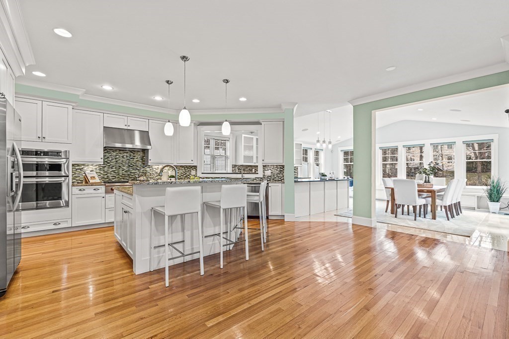 74 Oak Street Wellesley, MA 02482 - Photo 11 of 40 a dining hall with stainless steel appliances granite countertop a stove top oven a dining table and chairs