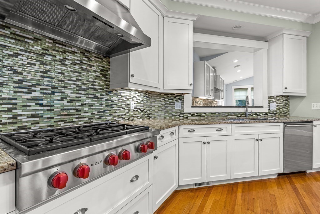 74 Oak Street Wellesley, MA 02482 - Photo 12 of 40 a kitchen with stainless steel appliances granite countertop a stove and a white cabinets