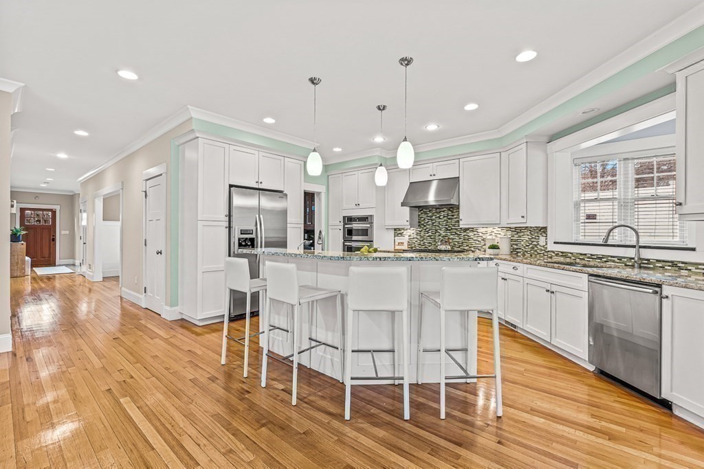 74 Oak Street Wellesley, MA 02482 - Photo 13 of 40 a kitchen with stainless steel appliances granite countertop a stove top oven a sink dishwasher and a refrigerator with wooden floor