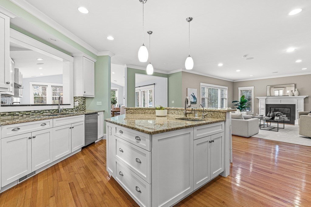 74 Oak Street Wellesley, MA 02482 - Photo 14 of 40 a kitchen with a stove a sink a center island and a wooden floor