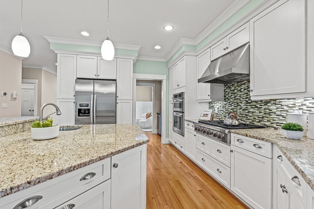 74 Oak Street Wellesley, MA 02482 - Photo 15 of 40 a kitchen with granite countertop a sink stainless steel appliances and white cabinets