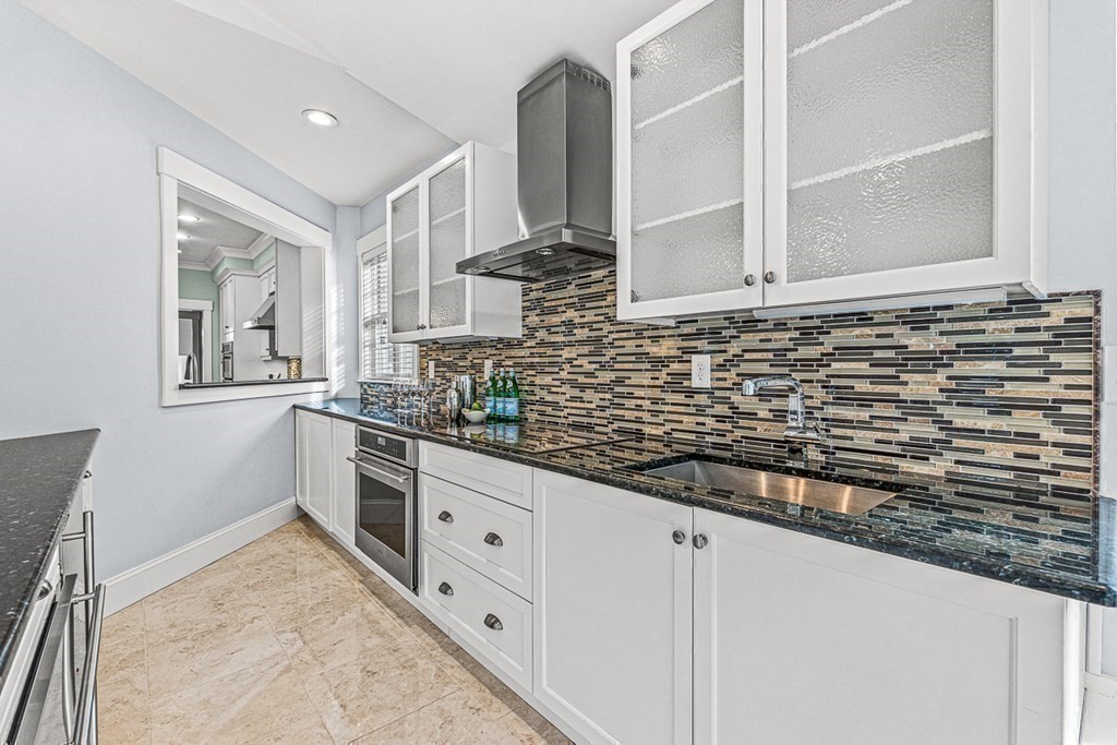 74 Oak Street Wellesley, MA 02482 - Photo 20 of 40 a bathroom with a sink and a mirror