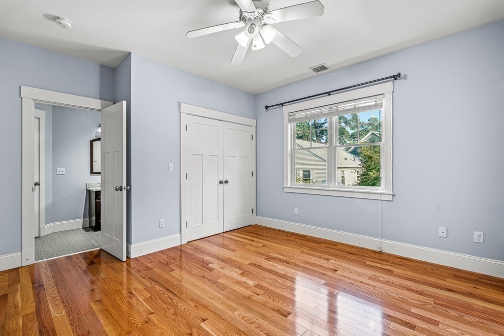 74 Oak Street Wellesley, MA 02482 - Photo 29 of 40 a view of an empty room with window and wooden floor