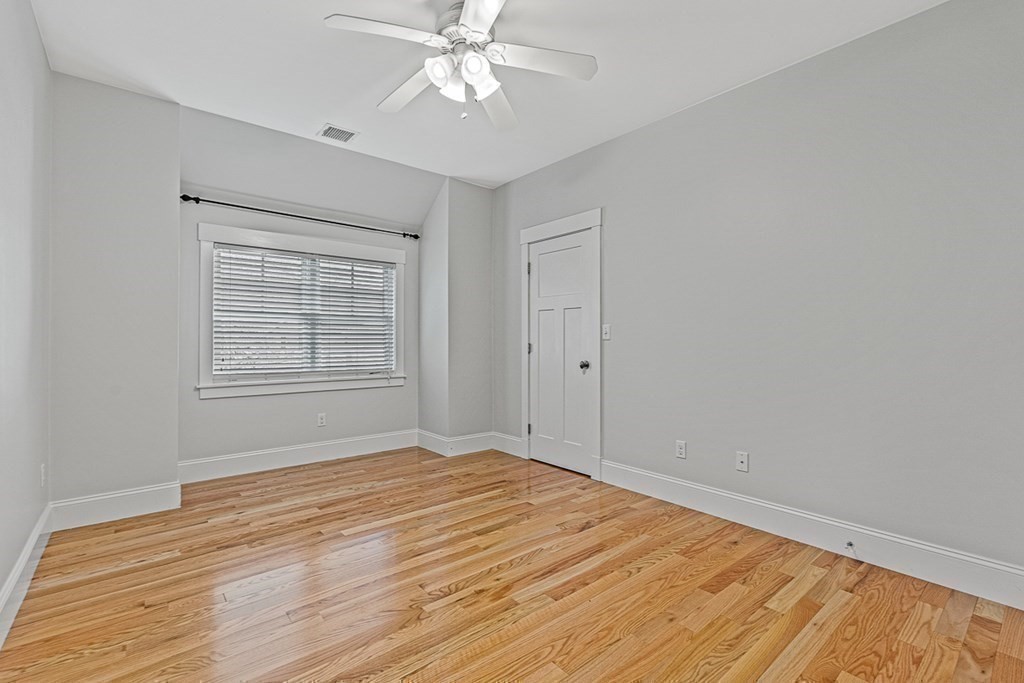 74 Oak Street Wellesley, MA 02482 - Photo 32 of 40 a view of empty room with wooden floor and fan