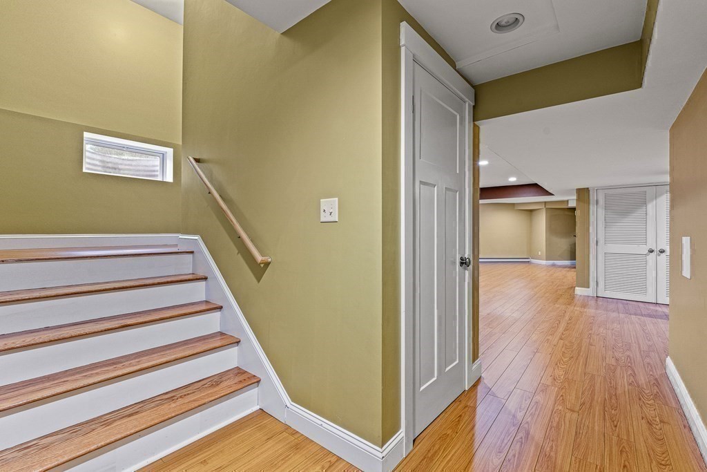 74 Oak Street Wellesley, MA 02482 - Photo 33 of 40 a view of a hallway with wooden floor and staircase