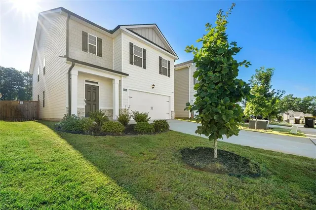 a front view of a house with garden