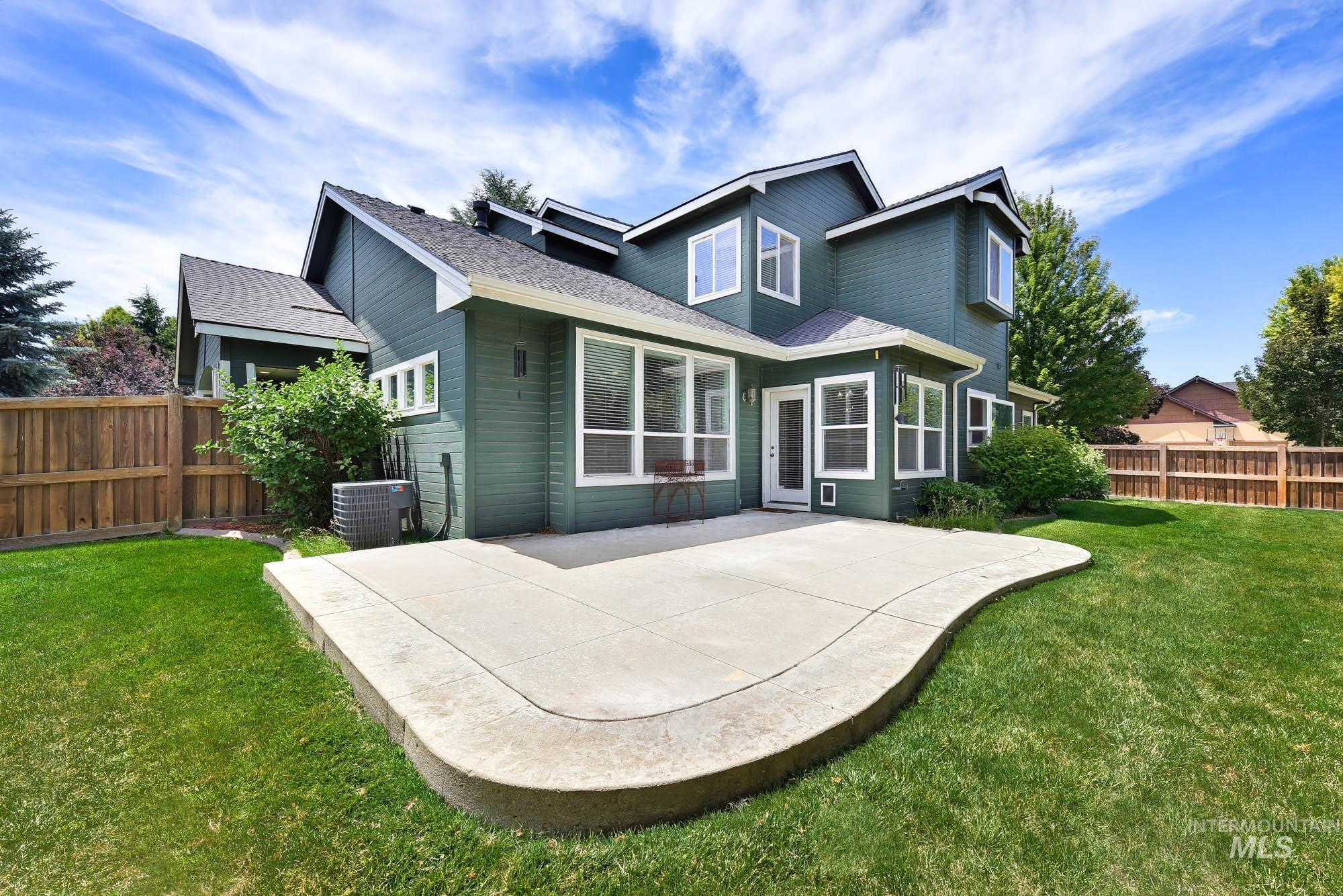 2172 West Cedar Grove Street Meridian, ID 83646 - Photo 39 of 49 Rear exterior featuring a large concrete patio, expansive lawn, and a privacy fence