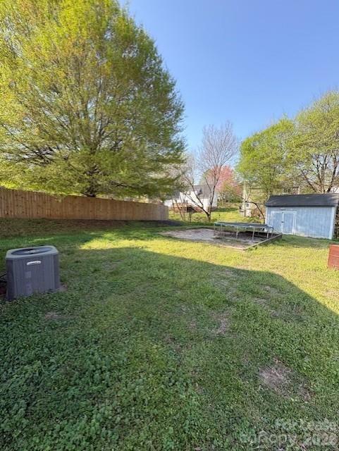 3065 Parade Lane Southwest, Unit 121 Concord, NC 28025 - Photo 11 of 12 a view of a house with a yard and a large tree