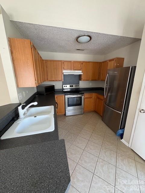 3065 Parade Lane Southwest, Unit 121 Concord, NC 28025 - Photo 4 of 12 a kitchen with a sink a stove and a refrigerator