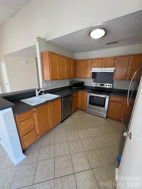 3065 Parade Lane Southwest, Unit 121 Concord, NC 28025 - Photo 5 of 12 a kitchen with stainless steel appliances granite countertop a sink dishwasher stove and cabinets