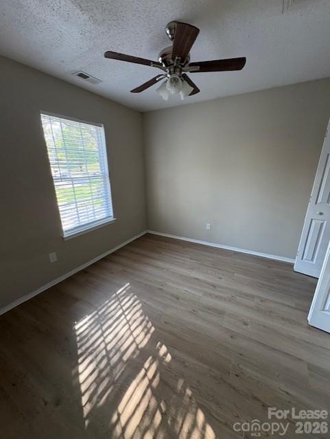 3065 Parade Lane Southwest, Unit 121 Concord, NC 28025 - Photo 6 of 12 a view of an empty room with wooden floor and a window