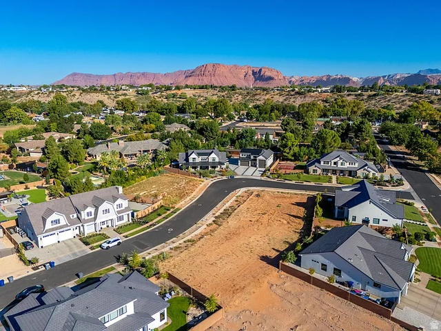 1240 North Gallen Road, Unit 12 Santa Clara, UT 84765 - Photo 11 of 19 Expansive undeveloped land parcel with surrounding residential properties and mountainous backdrop