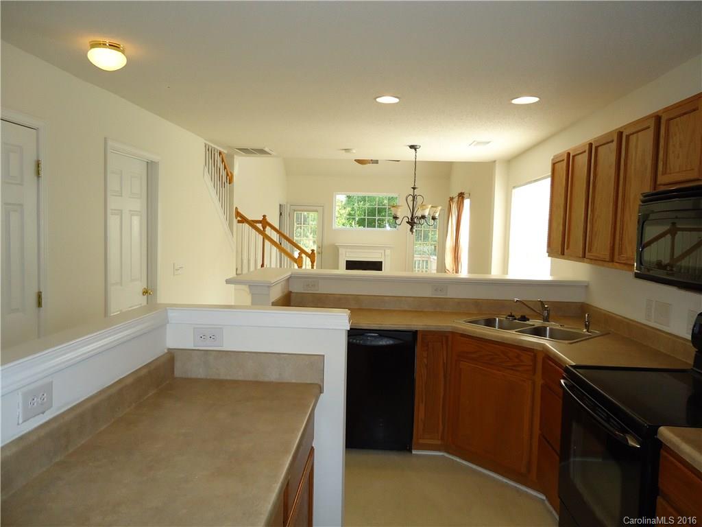 16824 Timber Crossing Road Charlotte, NC 28213 - Photo 4 of 23 a kitchen with stainless steel appliances granite countertop a sink stove and refrigerator