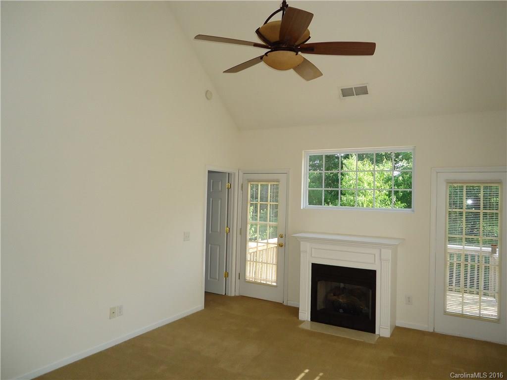 16824 Timber Crossing Road Charlotte, NC 28213 - Photo 5 of 23 a view of empty room with fireplace and fan