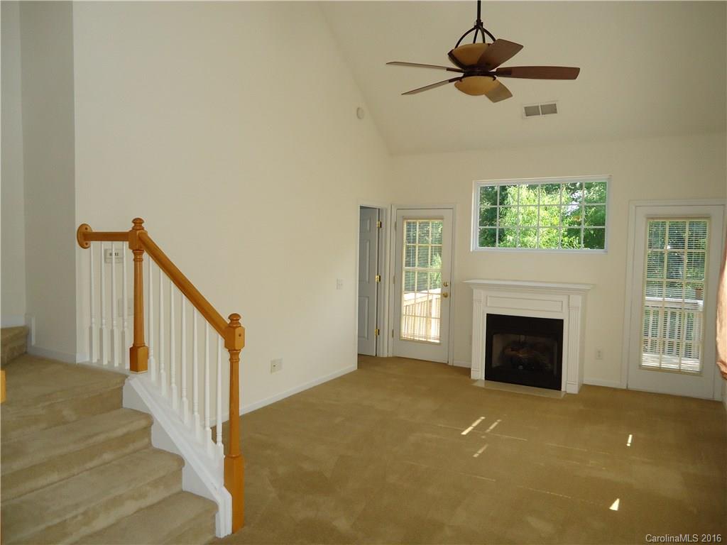 16824 Timber Crossing Road Charlotte, NC 28213 - Photo 6 of 23 a view of an empty room with a fireplace and a window