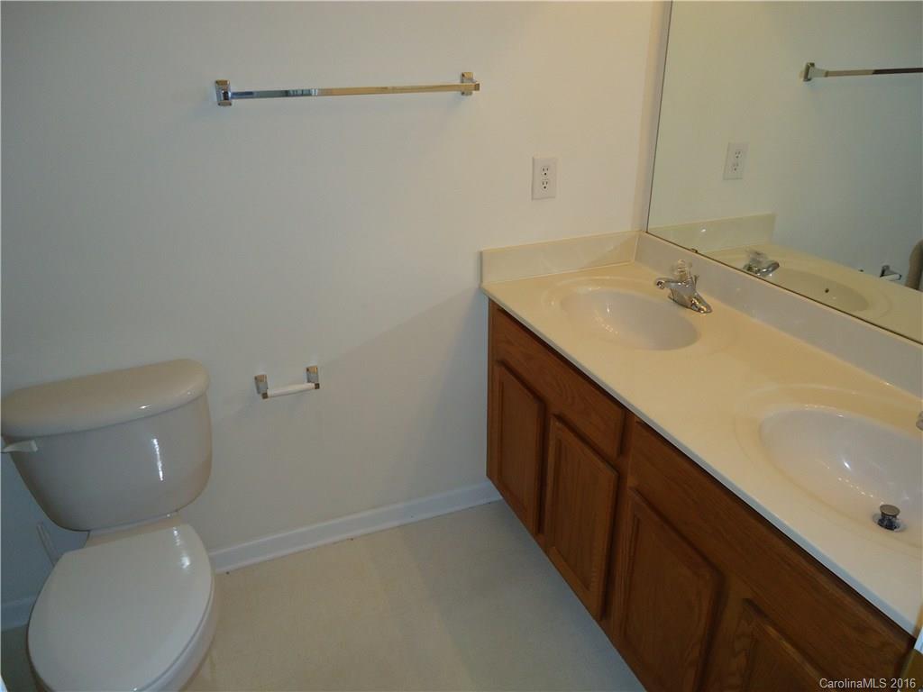16824 Timber Crossing Road Charlotte, NC 28213 - Photo 9 of 23 a bathroom with a toilet sink and mirror