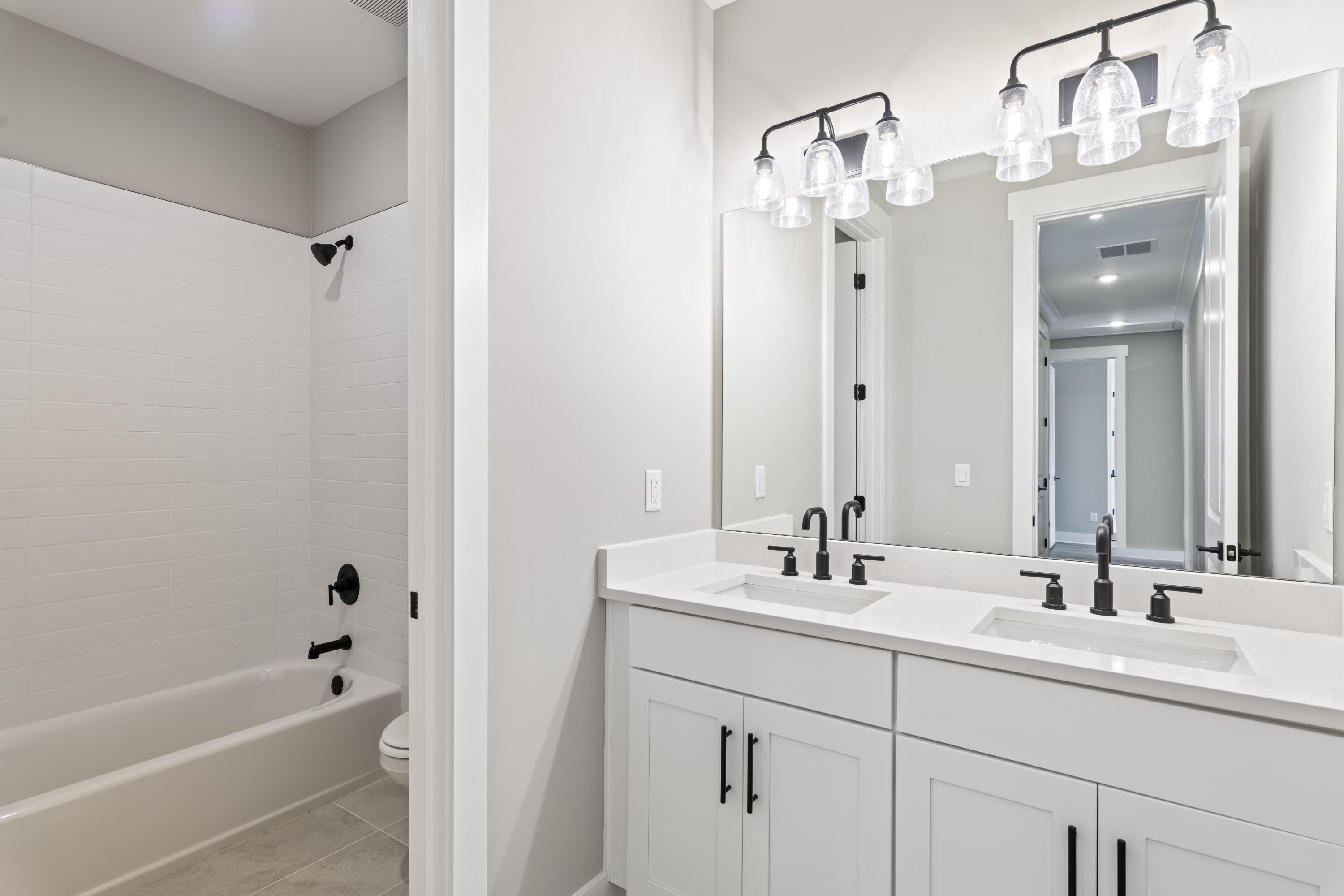 162 Channel Shoal Drive, Unit LOT 2 Santa Rosa Beach, FL 32459 - Photo 28 of 36 a bathroom with a double vanity sink mirror and bathtub