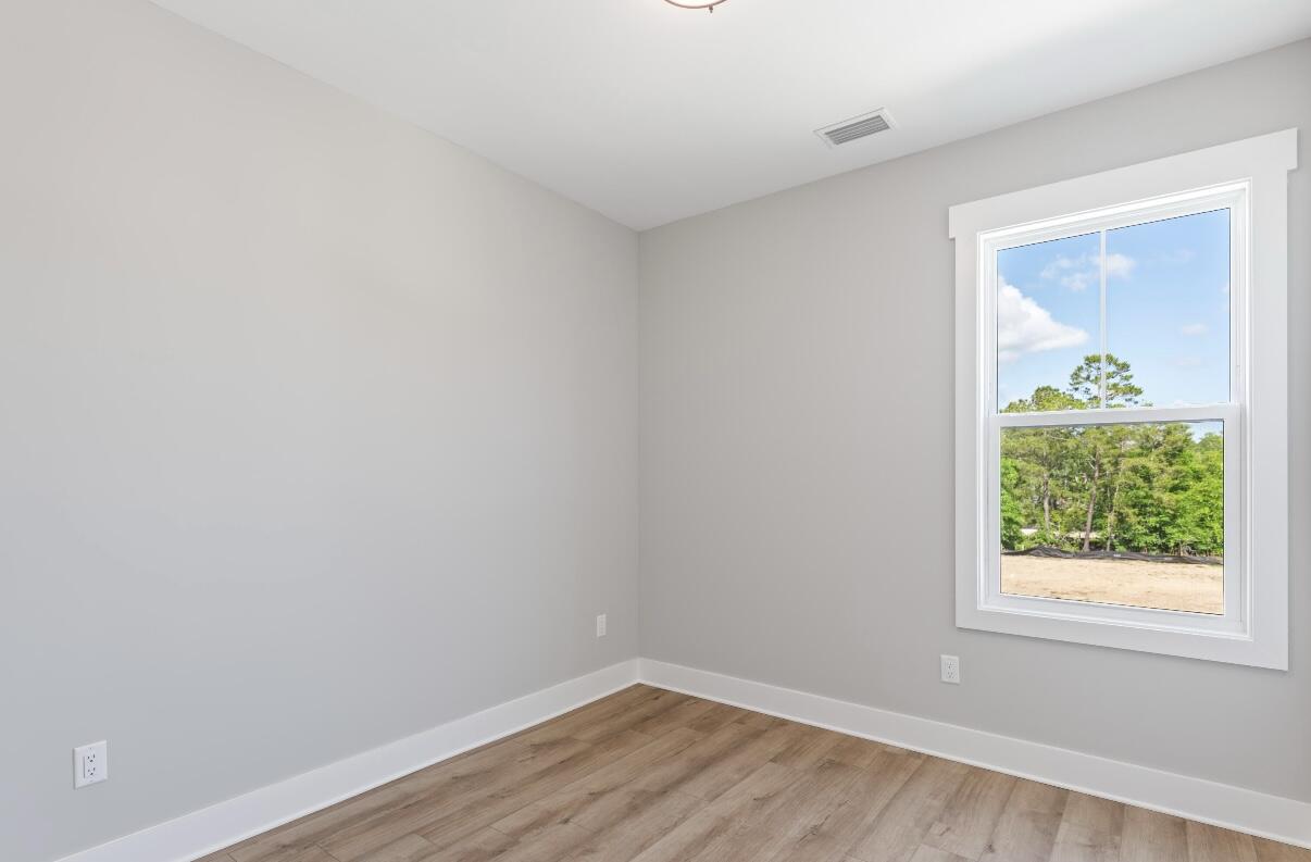 162 Channel Shoal Drive, Unit LOT 2 Santa Rosa Beach, FL 32459 - Photo 29 of 36 an empty room with wooden floor and a window