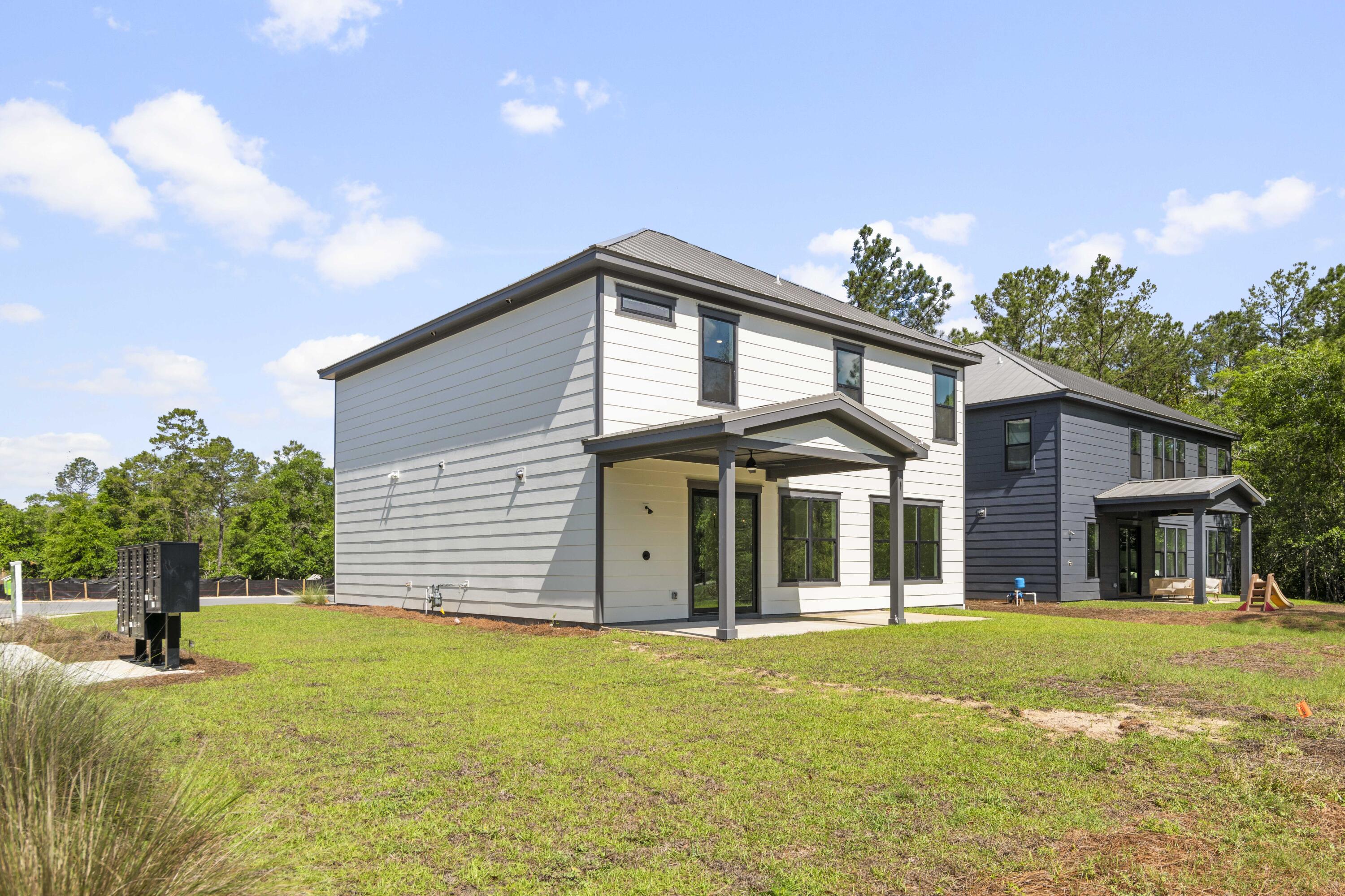 162 Channel Shoal Drive, Unit LOT 2 Santa Rosa Beach, FL 32459 - Photo 34 of 36 a front view of a house with a yard