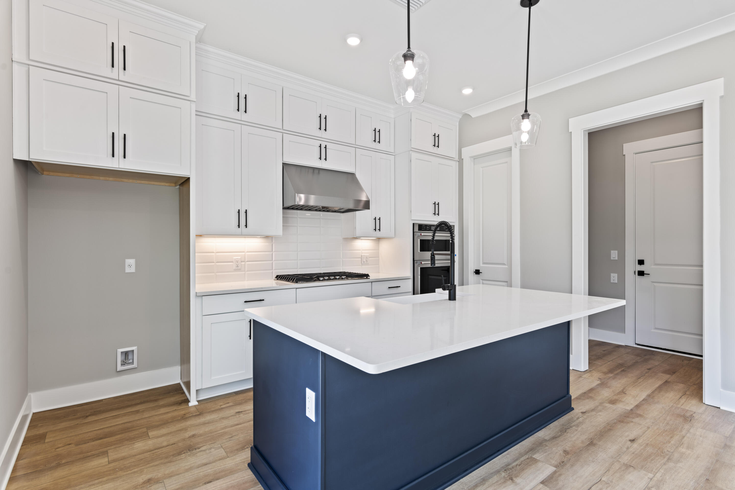 162 Channel Shoal Drive, Unit LOT 2 Santa Rosa Beach, FL 32459 - Photo 8 of 36 a kitchen with kitchen island a sink a stove a refrigerator and white cabinets