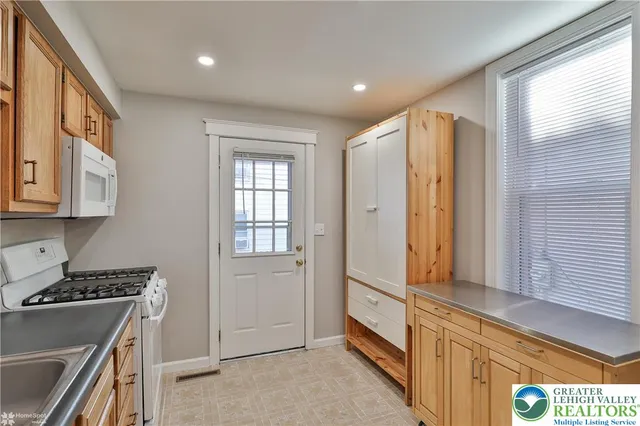 a kitchen with cabinets a sink and appliances