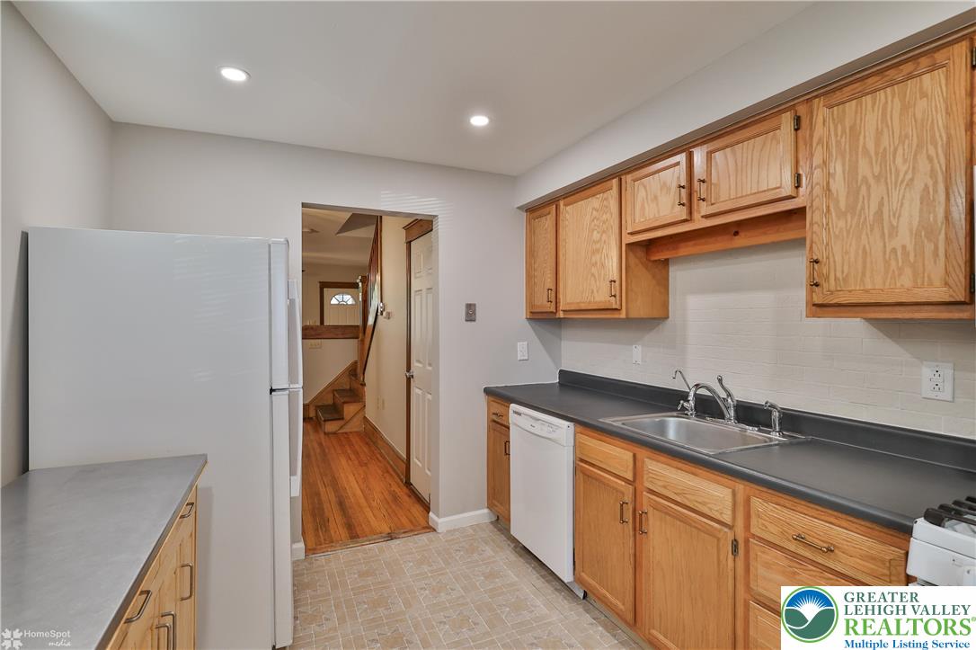 1035 Spring Street Bethlehem, PA 18018 - Photo 15 of 27 a kitchen with stainless steel appliances granite countertop a sink and cabinets