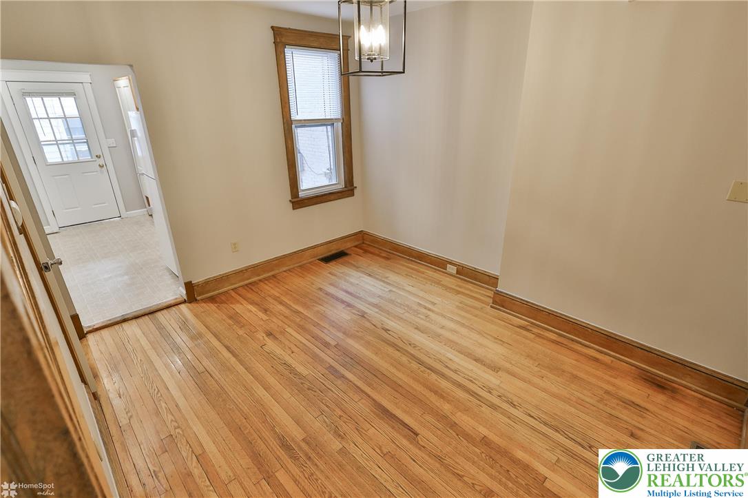1035 Spring Street Bethlehem, PA 18018 - Photo 16 of 27 a view of an empty room with wooden floor and a window