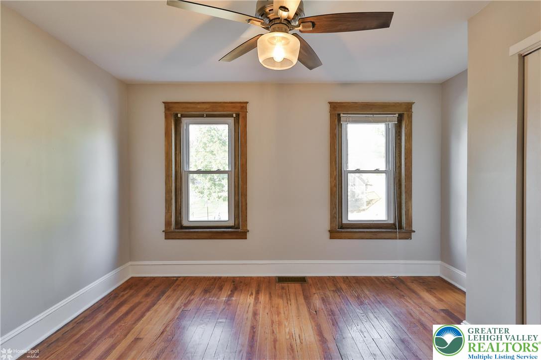 1035 Spring Street Bethlehem, PA 18018 - Photo 20 of 27 a view of an empty room with wooden floor and a window