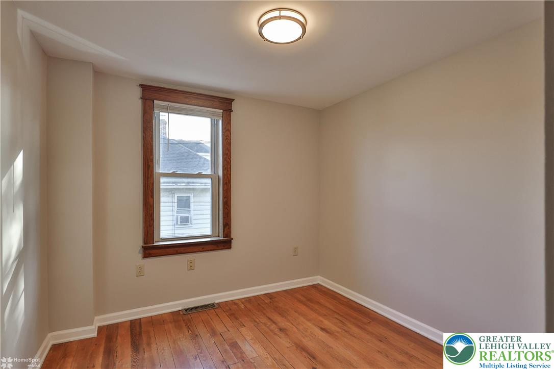 1035 Spring Street Bethlehem, PA 18018 - Photo 23 of 27 an empty room with wooden floor and windows