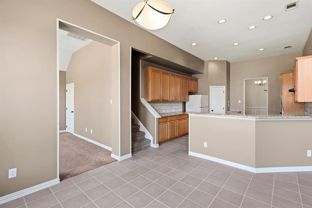 7517 Rodeo Drive Denton, TX 76208 - Photo 17 of 39 From the breakfast area, this is your view of the flex room, stairway to game room, and island kitchen.