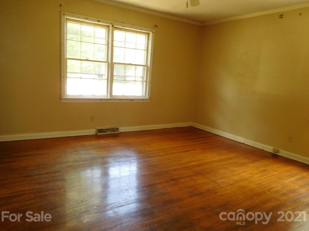 621 Charles Road Shelby, NC 28152 - Photo 12 of 17 an empty room with wooden floor and windows