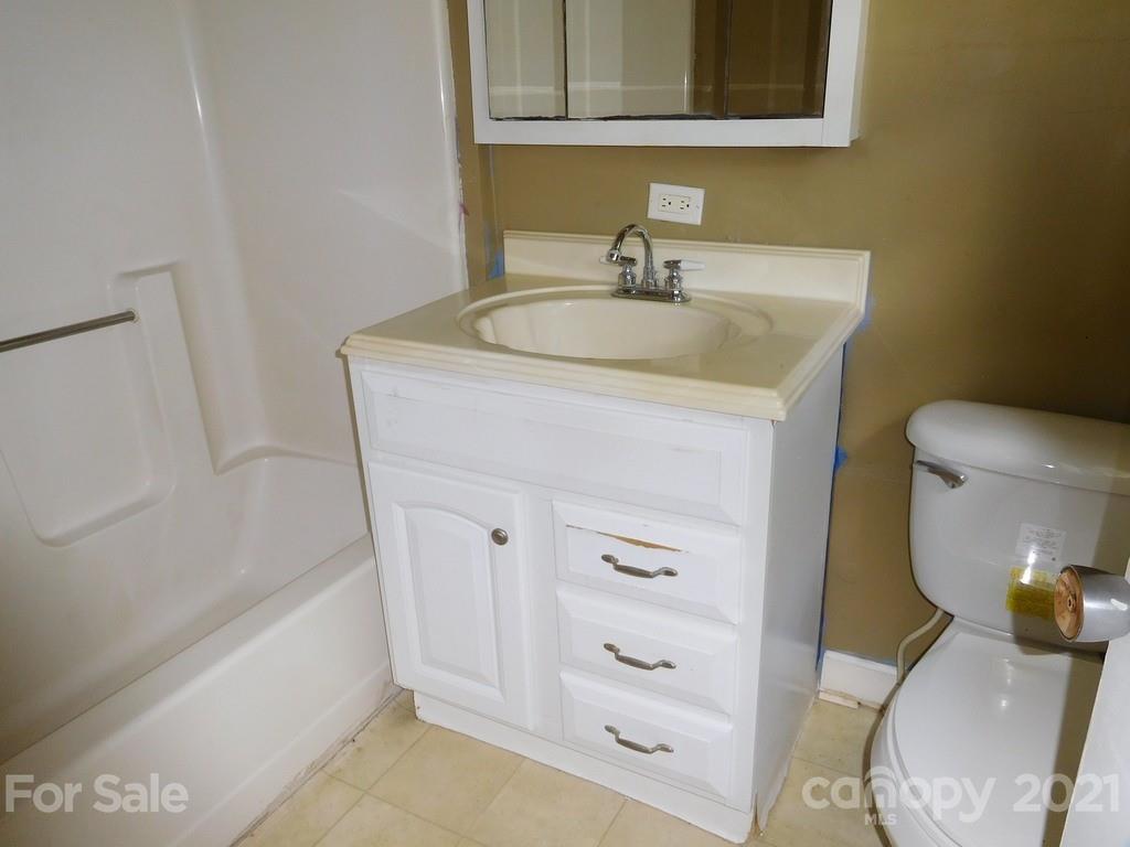 621 Charles Road Shelby, NC 28152 - Photo 13 of 17 a bathroom with a sink a toilet and mirror