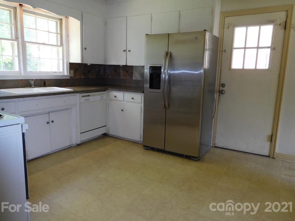 621 Charles Road Shelby, NC 28152 - Photo 6 of 17 a kitchen with stainless steel appliances granite countertop a refrigerator a sink a stove a microwave a counter space and cabinets