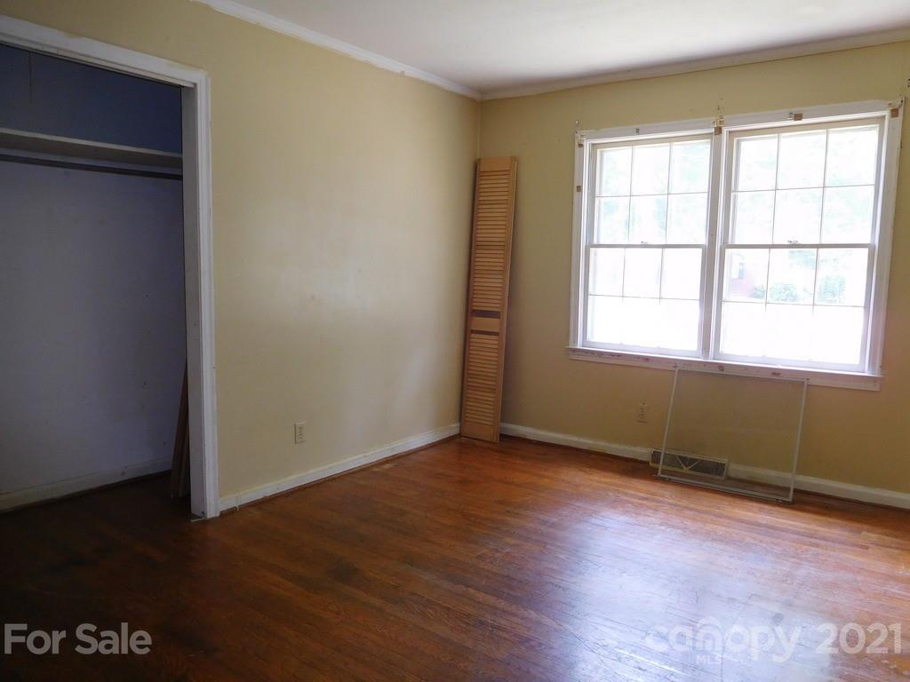 621 Charles Road Shelby, NC 28152 - Photo 9 of 17 an empty room with wooden floor and windows