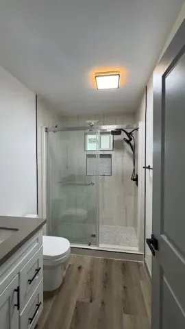 a bathroom with a glass shower door