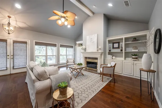 a living room with fireplace furniture and a large window