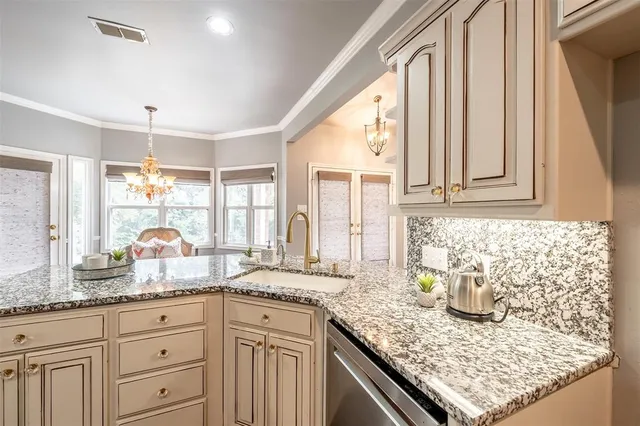 a kitchen with granite countertop a stove and a sink