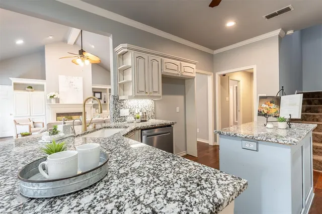 a kitchen with stainless steel appliances granite countertop a stove and cabinets