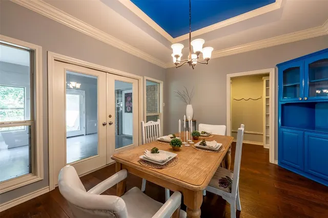 a view of a dining room with furniture and a chandelier