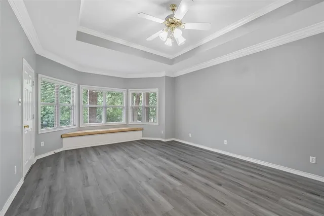 a bathroom with a granite countertop sink a large mirror and a bathtub with shower