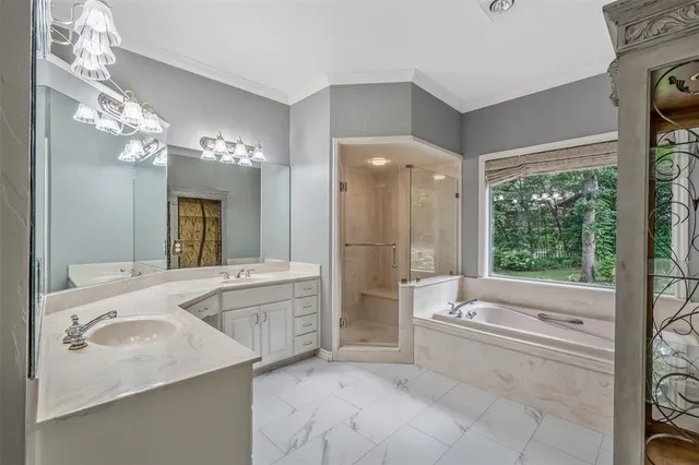 an empty room with chandelier fan and windows